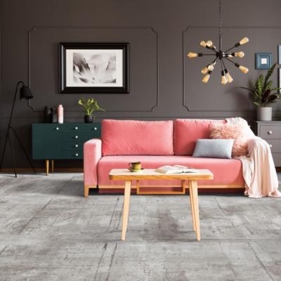 Devoted Carpet in Pewter in living room with pink couch and wood coffee table